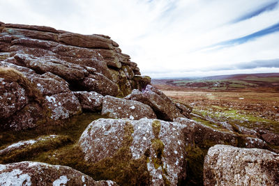 Rock formations on landscape against sky