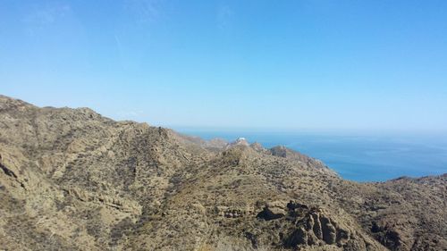 Panoramic view of beach against clear blue sky