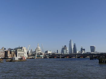 River in city against clear sky