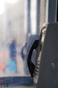 Close-up of telephone on window