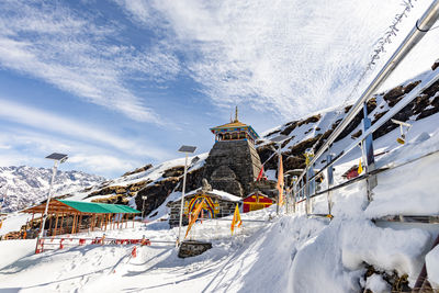 Isolated ancient holy hindu temple in himalayan mountain range with bright blue sky