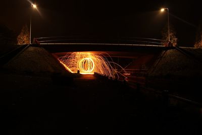 Illuminated lights against sky at night