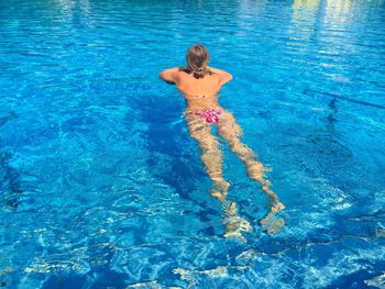 High angle view of woman swimming in pool