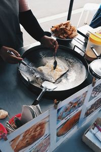 Midsection of woman preparing food in kitchen