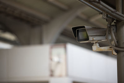 Low angle view of electric lamp against wall in building