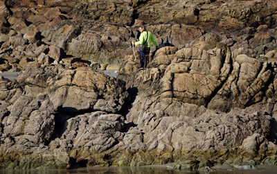 Rear view of man walking on rock