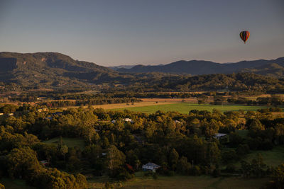 View of hot air balloon flying over land