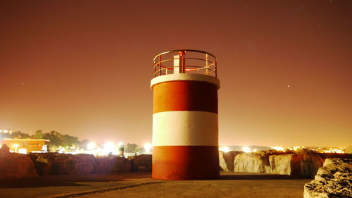 Lighthouse against sky at night