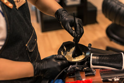 Midsection of barber working in salon