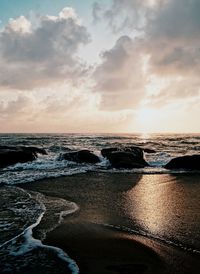 Scenic view of beach against sky during sunset