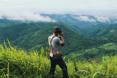 Full length of young man standing on mountain