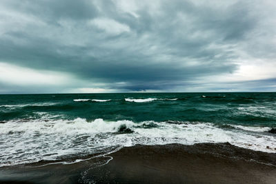 Scenic view of sea against cloudy sky