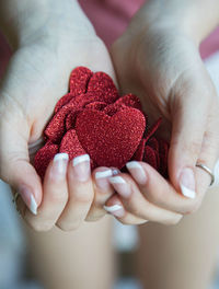 Close-up of hands holding heart shape glitters