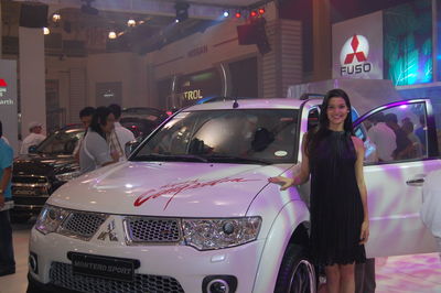 Portrait of young woman standing in car