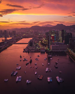 High angle view of buildings in city during sunset