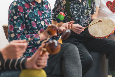 Midsection of man playing drum