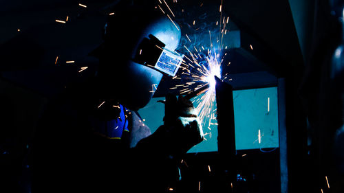 Man working in factory at night