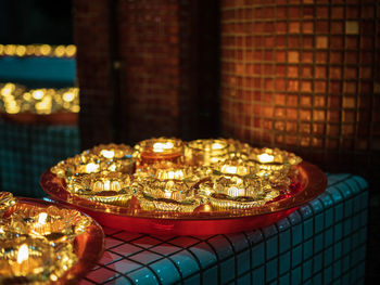 Close-up of illuminated candles on table