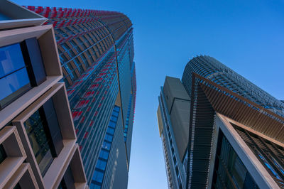 Low angle view of modern buildings against clear blue sky.  barangaroo  international towers