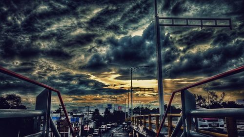 Reflection of cloudy sky on railing