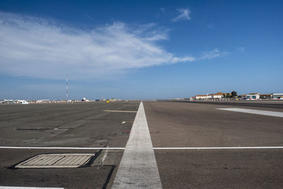 Road by airport against sky