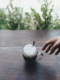 Person holding ice cream on table