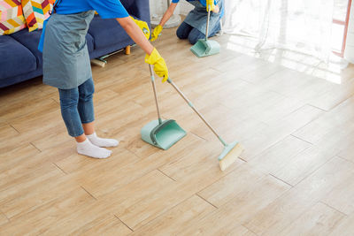 Low section of woman walking on hardwood floor