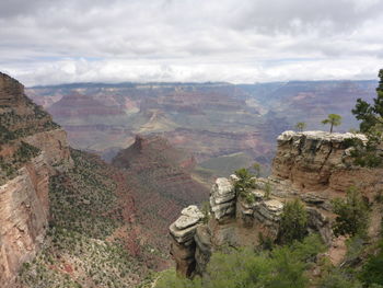 Scenic view of mountains against cloudy sky