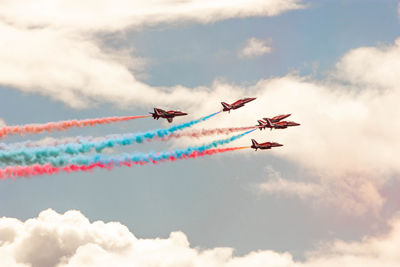 Low angle view of airshow against sky