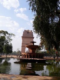 Built structure in lake against sky