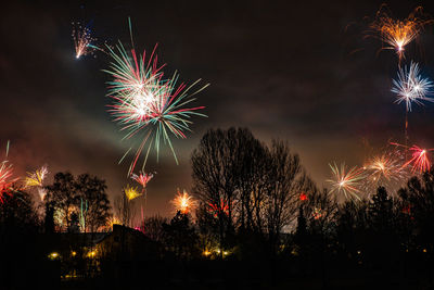 Low angle view of firework display at night