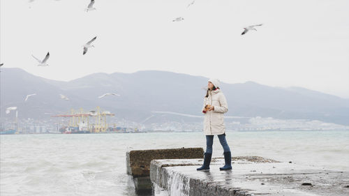 Man standing by sea against sky