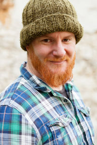 Portrait of man wearing knit hat standing outdoors