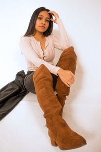 Portrait of beautiful young woman against white background