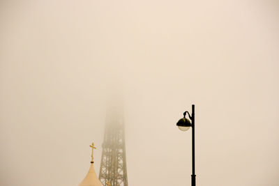 Low angle view of bird perching against clear sky