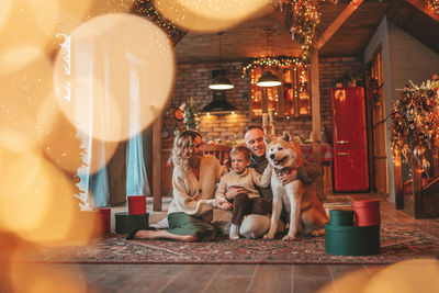 Candid authentic happy family during wintertime together enjoying holidays with dog at xmas
