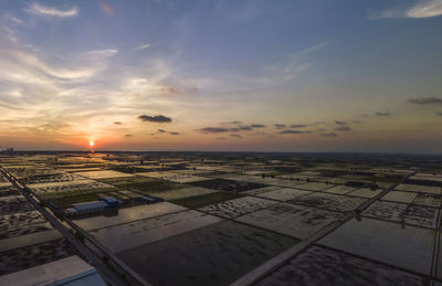 Aerial view of cityscape against sky during sunset