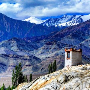 Scenic view of mountains against cloudy sky