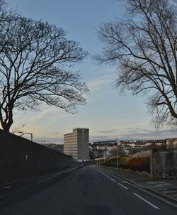 Road by city against sky