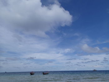 Scenic view of sea against cloudy sky