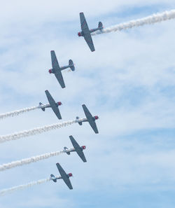 Low angle view of airshow against sky