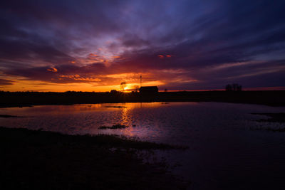 A dramatic sunrise over the pond with color reflections.