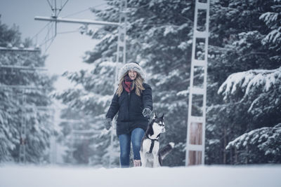 Full length of woman standing in snow