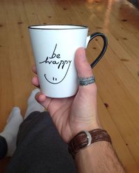 Midsection of woman holding coffee cup