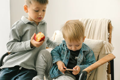 Side view of boy eating apple