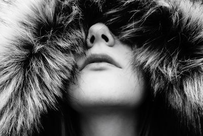 Close-up of young woman in fur coat