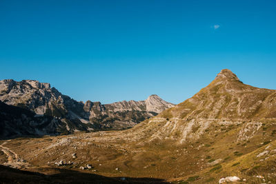 Scenic view of mountains against clear blue sky