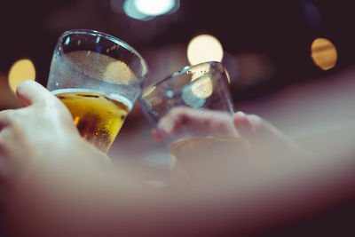 Close-up of hand holding beer glass