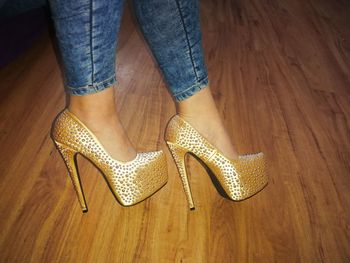 Low section of woman standing on hardwood floor