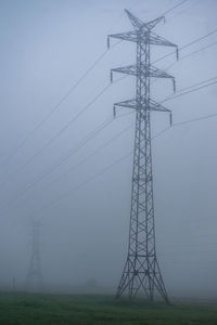 Power line in a foggy morning. the concept of electricity and energy.